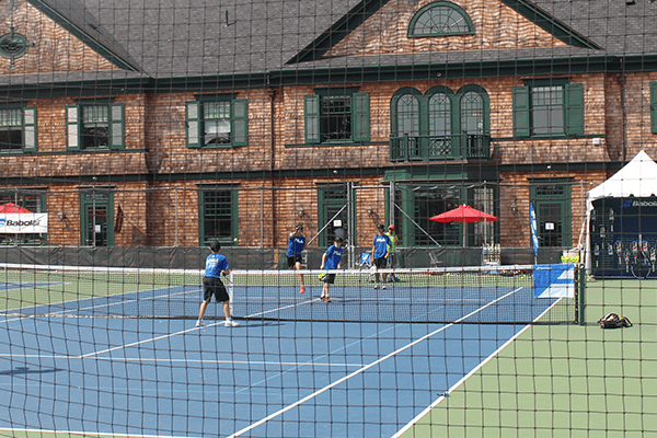A group of people playing tennis on the court
