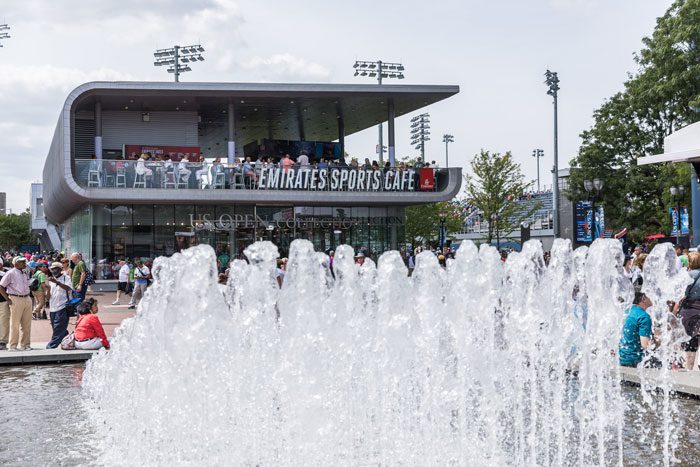 A fountain with people in the background at an event.