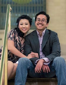 A man and woman sitting on the ground.