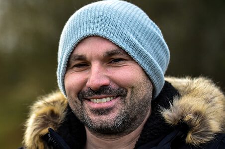 A man wearing a blue hat and jacket.