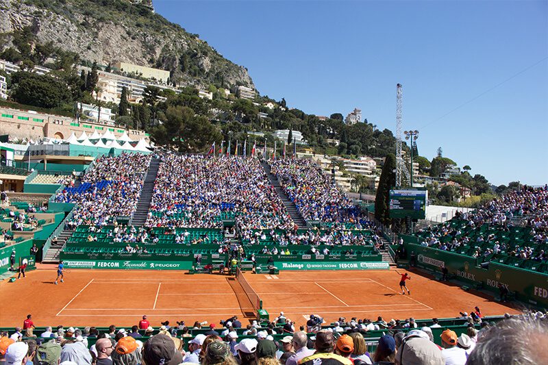 A crowd of people watching a tennis match.