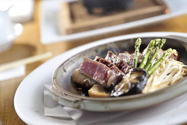 A plate of food with asparagus and meat.