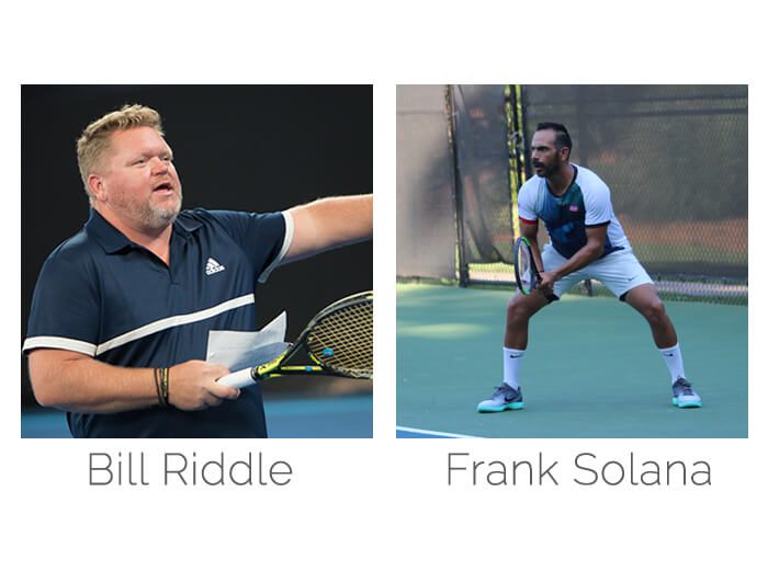 Two men are playing tennis on a court.