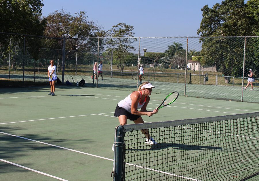 A woman is playing tennis on the court